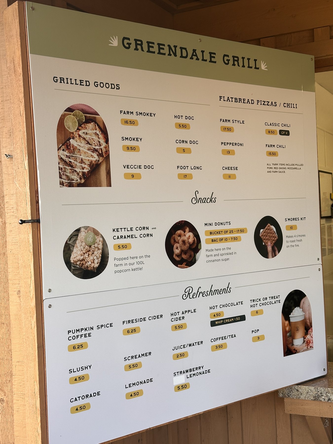 Greendale Grill menu board listing grilled goods, flatbread pizzas, snacks and drinks with prices