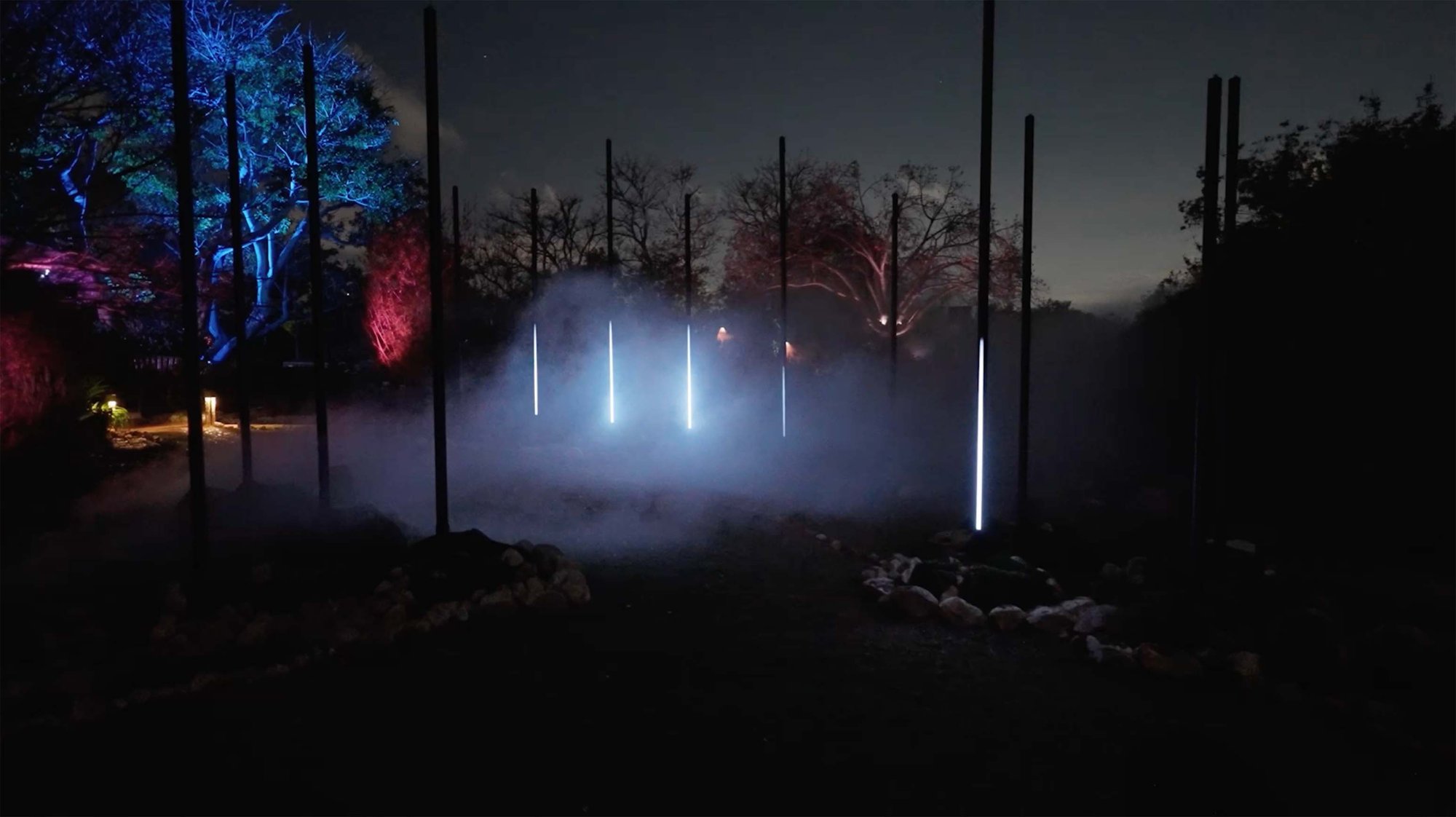 Glowing light poles in fog at Astra Lumina