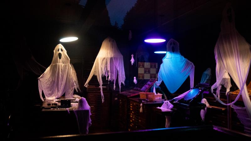 Glowing ghost figures in a Haunted Village display at Burnaby Village Museum